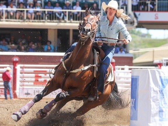 Katelyn Scott applauds her horse after barrel race win at Stampede ...