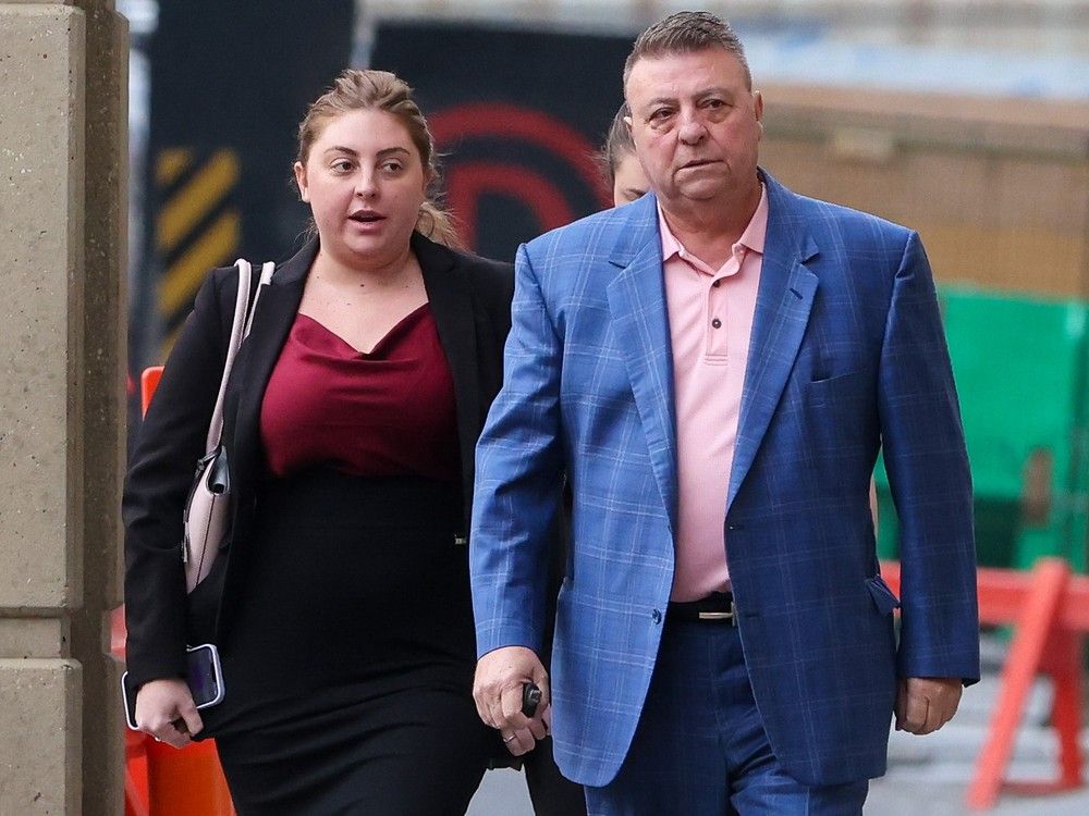  former calgary city councillor joe magliocca walks with family members toward the calgary courts centre for his trial on sept. 9, 2024.