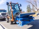 City of Calgary worker Carlos Santos demos a machine for clearing snow on sidewalks and pathways on Wednesday, Oct. 16, 2024.