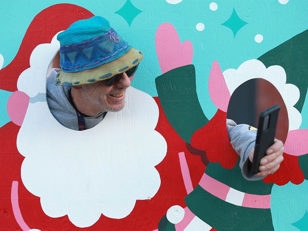 Larry Kemble takes a moment tor a Santa selfie at a fun display on 10th Street N.W. in Kensington in Calgary on Friday, Dec. 20, 2024.