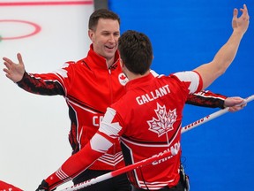 Team Canada skip Brad Gushue and Brett Gallant celebrate after defeating the USA to win the bronze medal in men's curling at the Beijing 2022 Winter Olympics
