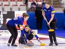 Team Alberta skip Selena Sturmay throws to second Dezaray Hawes (left) and lead Paige Papley during the Scotties Tournament of Hearts at WinSport Arena in Calgary on Feb. 21, 2024.