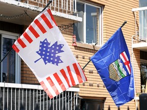 A flag bearing the Canadian maple leaf combined with the American stars and stripes is shown hanging beside an Alberta flag in the northeast community of Bridgeland on Thursday, April 24, 2025.