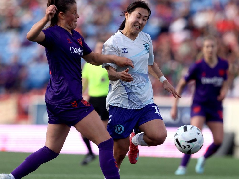  calgary wild fc christie gray battles ottawa rapid fc choo hyojoo in first half nsl action at mcmahon stadium in calgary on may 11.