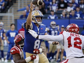Winnipeg Blue Bombers quarterback Zach Collaros (8) throws as he gets pressure from the Calgary Stampeders during first-half CFL action in Winnipeg on Friday, July 18, 2025.