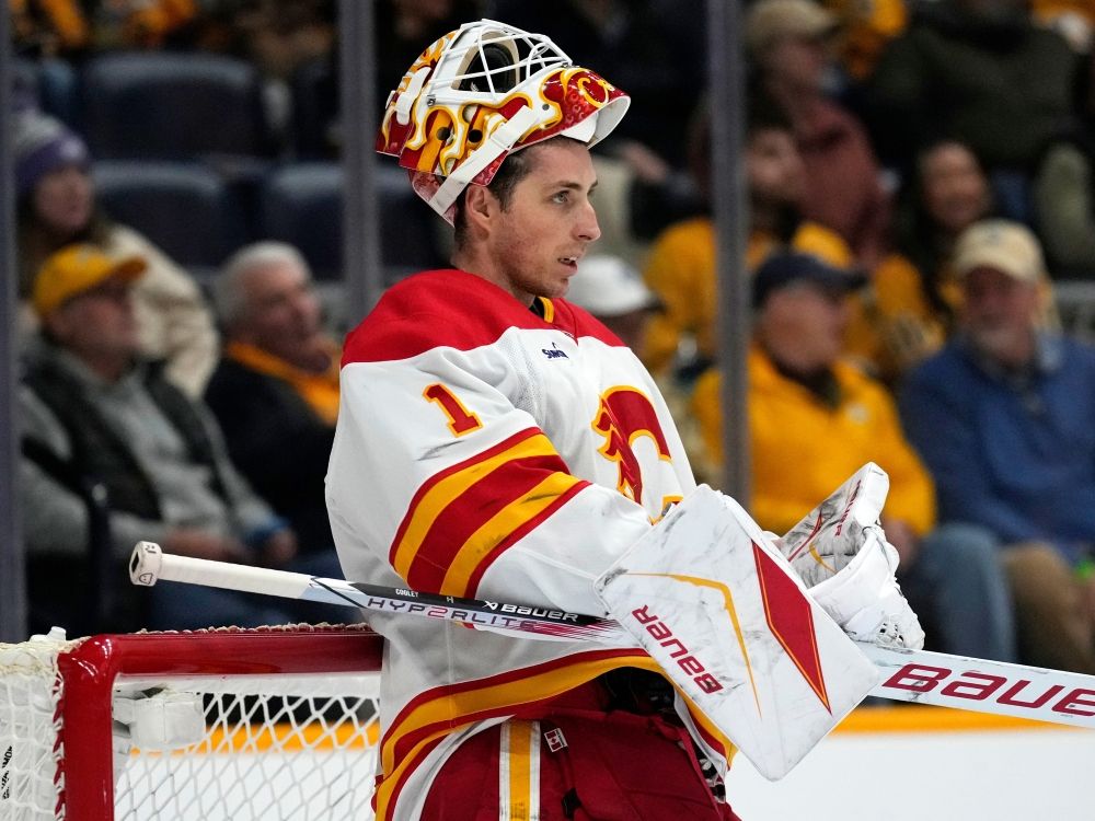 Calgary Flames goaltender Devin Cooley takes a break during a game against the Nashville Predators.