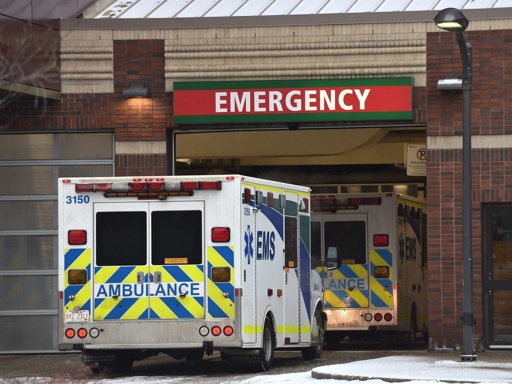 An ambulance waits outside the University of Alberta Hospital emergency area in Edmonton on Jan. 24, 2022.