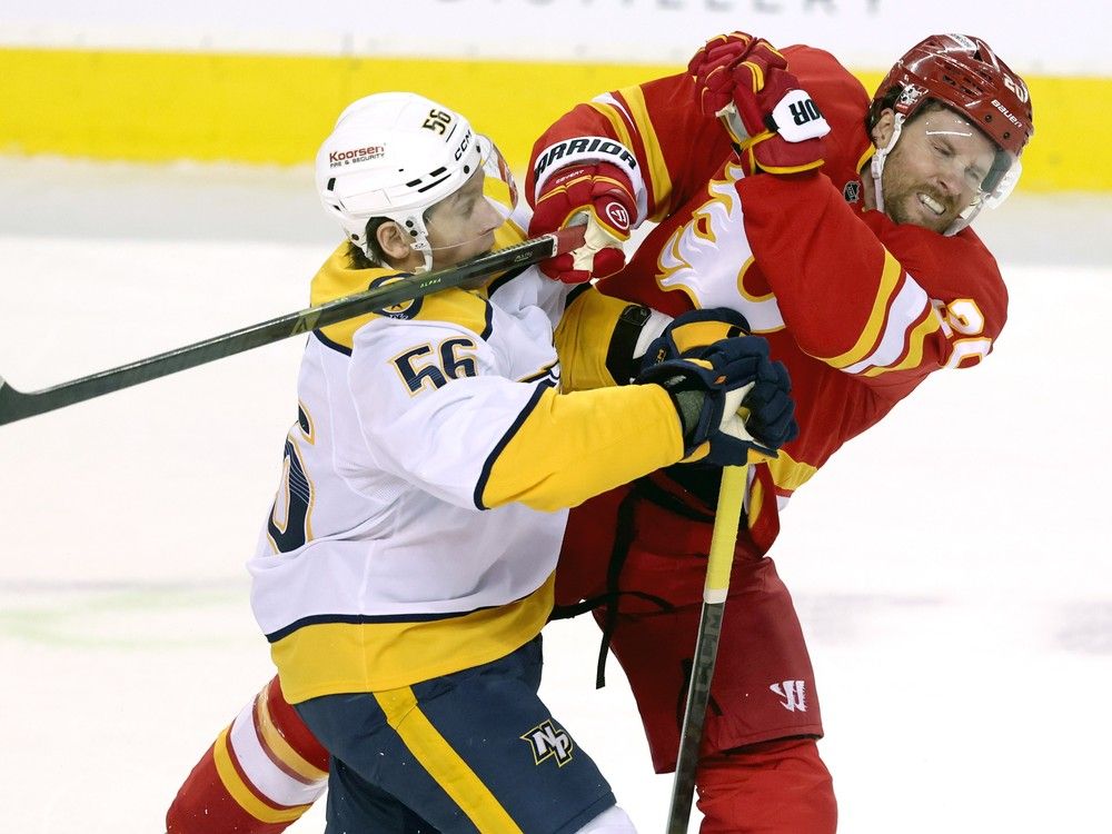 Calgary Flames Blake Coleman battles Nashville Predators Erik Haula in first period NHL action at the Scotiabank Saddledome in Calgary on Saturday
