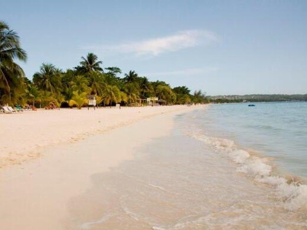 A Calgary company is mourning the loss of a team member who drowned Tuesday after a boat capsized off the coast of Negril, Jamaica.