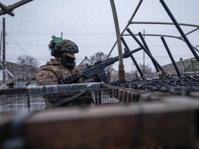 In this photo provided by Ukraine's 93rd Kholodnyi Yar Separate Mechanized Brigade press service, a soldier in a vehicle gets ready to shoot down Russian FPV drones in Donetsk region, Ukraine, Saturday, Jan. 31, 2026.