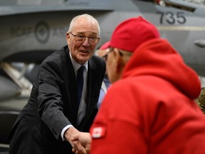 Defence Minister Bill Blair shakes the hand of a Canadian Ranger following an announcement about increasing the Canadian Armed Forces' presence and readiness across the Arctic and the North during a press conference in Iqaluit on Thursday, March 6, 2025.