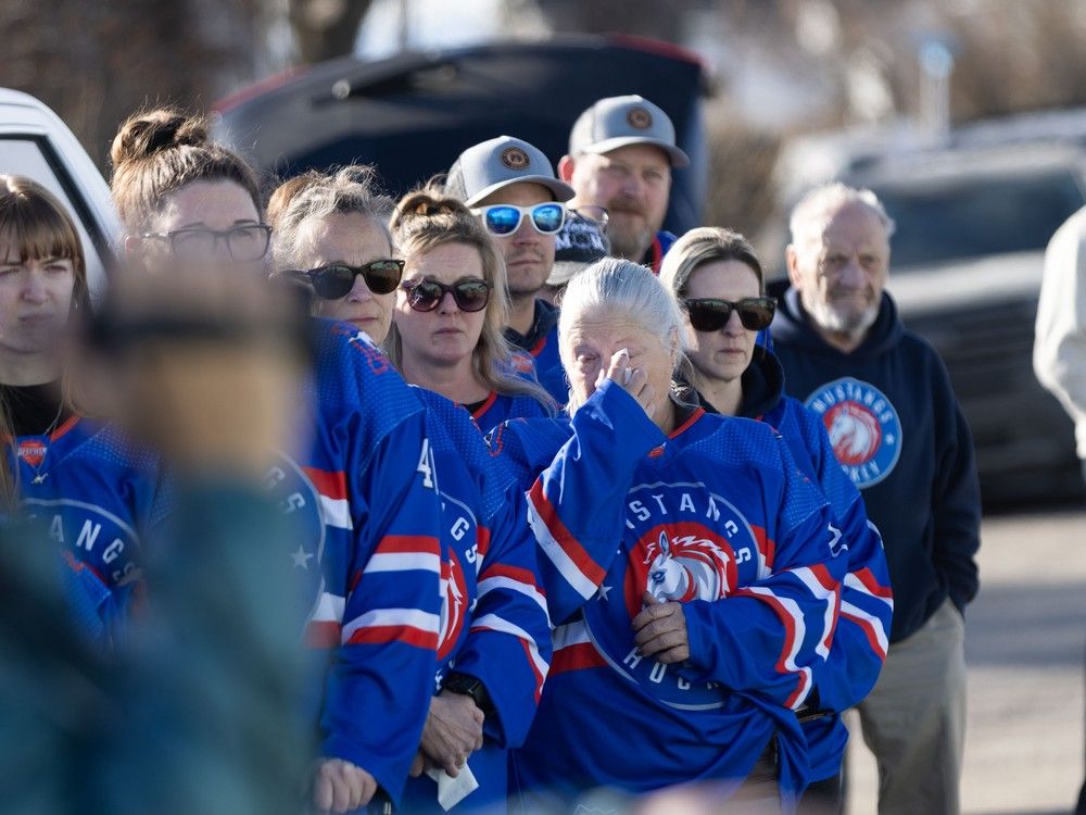  Southern Alberta Mustangs hockey parents and billet families gather outside of Stavely Arena on Tuesday, February 3, 2026.