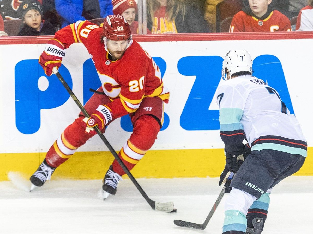 Calgary Flames centre Blake Coleman moves to evade Seattle Kraken right winger Jordan Eberle in the second period at the Scotiabank Saddledome on Monday, January 5, 2026. Brent Calver/Postmedia