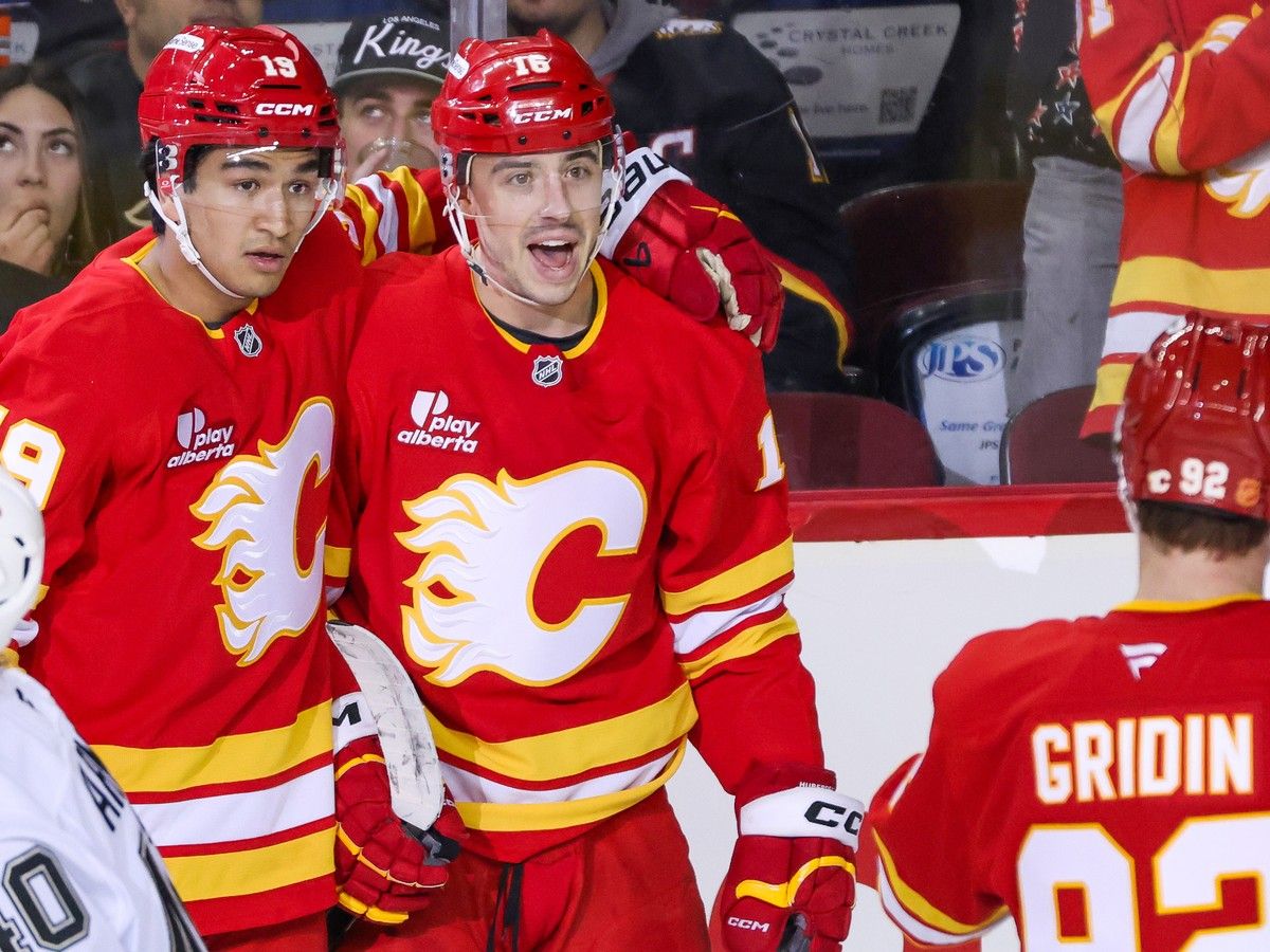 Calgary Flames forward Morgan Frost, centre, celebrates his goal on the Los Angeles Kings with teammates defenceman Zayne Parekh