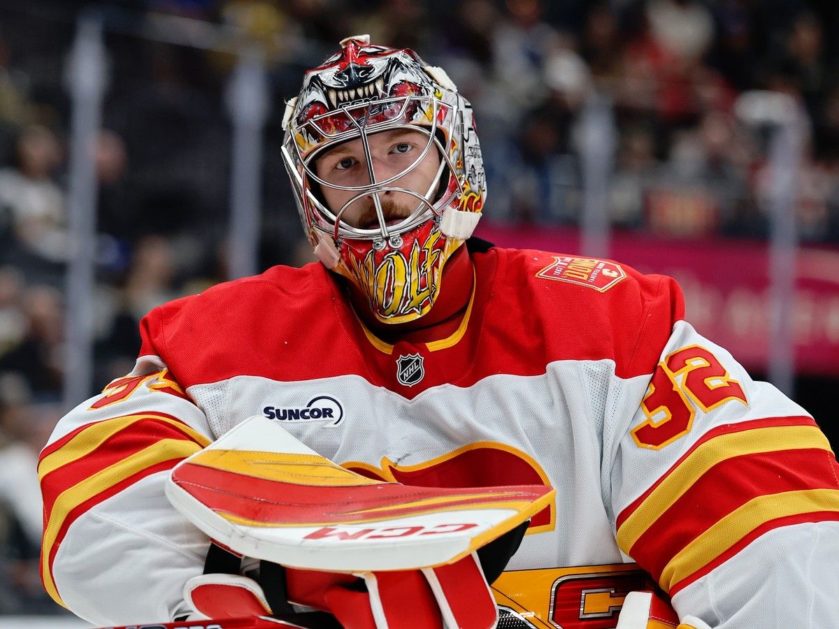 Dustin Wolf #32 of the Calgary Flames takes a break during a stoppage in play in the second period against the Vegas Golden Knights at T-Mobile Arena