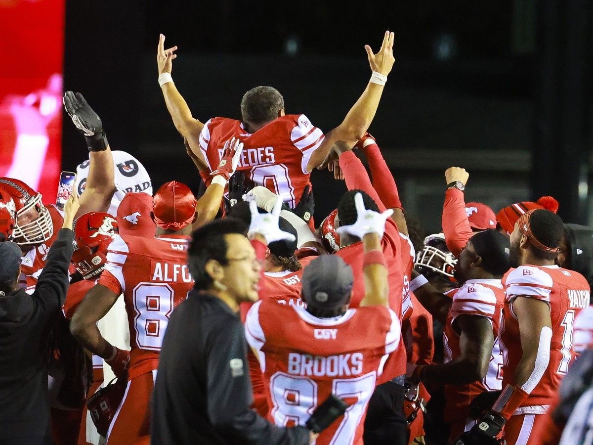 Calgary Stampeders kicker René Paredes is lifted up by his team after kicking the game winning field goal against