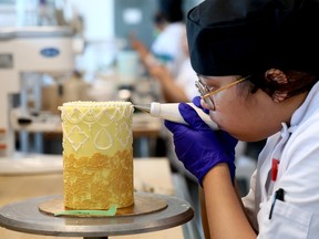 SAIT student making a cake