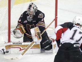 Calgary Hitmen goalie Nick Schneider, left, blocks a shot on net from Prince George Cougars Nikita Popugaev in WHL action at the Scotiabank Saddledome in Calgary, on Sunday, October 22, 2017. Leah Hennel/Postmedia

POSTMEDIA CALGARY
Leah Hennel, Leah Hennel/Postmedia