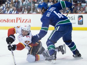 Johnny Gaudreau, Michael Del Zotto

Calgary Flames' Johnny Gaudreau, left, reaches for the puck from his knees in front of Vancouver Canucks' Michael Del Zotto during first period NHL hockey action in Vancouver on Saturday, October 14, 2017. THE CANADIAN PRESS/Darryl Dyck ORG XMIT: VCRD108
DARRYL DYCK,