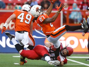 Calgary Stampeders special-teams star Charlie Power puts a hit on Darious Lane of the BC Lions during CFL action in Calgary, Alta.. on Friday June 12, 2015.