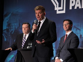 Brian Jean, centre, speaks at a UCP leadership debate with Jason Kenney, left, and Doug Schweitzer in Fort McMurray on Oct. 12.