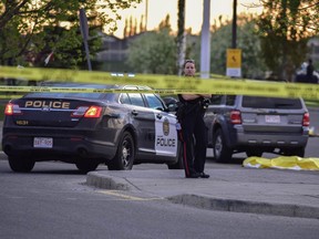Calgary police attend the scene of a double-homicide in the parking lot of the Real Canadian Superstore on 130 Ave. S.E. on May 21, 2017. Bryan Passifiume/Postmedia Network