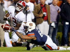 Auburn defensive back Carlton Davis (rigth) breaks up a pass intended for Alabama wide receiver Calvin Ridley in an Iron Bowl yesterday that saw the No. 1 Crimson Tide upset by Davis and the host Tigers in Auburn, Ala.