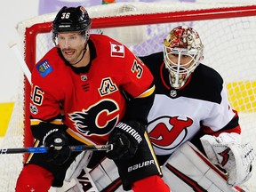 Calgary Flames Troy Brouwer attempts to redirect a puck past goalie Keith Kinkaid of the New Jersey Devils during NHL hockey at the Scotiabank Saddledome in Calgary on Sunday, November 5, 2017.