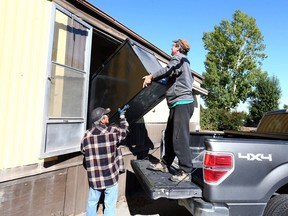 Kelly (didn't want his last name used) (L) gets help from his brothers as they move a fridge out of a narrow door at the Midfield Trailer Park in northeast Calgary Saturday, September 23, 2017. Kelly has lived in the park at #6  for the past five years and was moving large items out of the trailer as the end-of-the-month deadline looms for residents. Jim Wells/Postmedia

Postmedia Calgary
JimWells/Postmedia