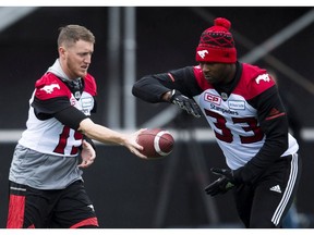 Calgary Stampeders quarterback Bo Levi Mitchell (19) hands the ball off to teammate Jerome Messam (33) during practice ahead of the105th Grey Cup championship football game against the Toronto Argonauts, in Ottawa on Saturday, November 25, 2017. THE CANADIAN PRESS/Nathan Denette