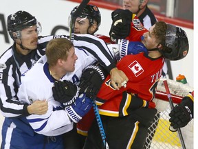 Leafs (L) Leo Komarov roughts it up with Flames Matthew Tkachuk during NHL action between the Toronto Maple Leafs and the Calgary Flames in Calgary Tuesday, November 28, 2017.