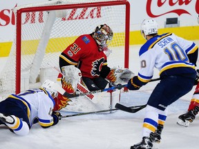 Calgary Flames goaltender Eddie Lack makes a save on a shot by Jaden Schwartz of the St. Louis Blues during NHL hockey at the Scotiabank Saddledome in Calgary on Monday, November 13, 2017. Al Charest/Postmedia
