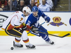 Toronto Maple Leafs Mitchell Marner and  Calgary Flames TJ Brodie battle for the puck at the Air Canada Centre in Toronto on Jan. 23, 2017.