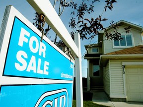 A for sale sign sits outside this home in Coventry Hills, an area with an ample supply of homes on the market, on Monday morning. Photo credit: Colleen De Neve / Calgary Herald