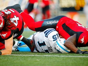 Toronto Argonauts quarterback Ricky Ray is sacked by Alex Singleton and Micah Johnson of the Calgary Stampeders during CFL football on Saturday, August 26, 2017.