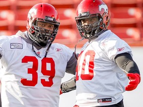 Defensive linemen Charleston Hughes (left) and Shawn Lemon (right) were Stampeders teammates as recently as three years ago