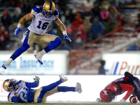 The Calgary Stampeders' Reggie Begelton (right) collides with Winnipeg Blue Bombers Taylor Loffler , #16, and Brandon Alexander during CFL action at McMahon Stadium in Calgary, Alta.. on Friday November 3, 2017.