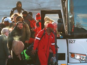A subdued Stampeders team arrives back at McMahon Stadium on Monday.