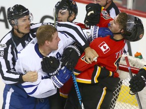 Maple Leafs' Leo Komarov roughs it up with Flames' Matthew Tkachuk on Nov. 28, 2017
