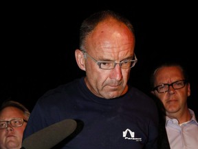 Douglas Garland is escorted into a Calgary police station in connection with the disappearance of Nathan O'Brien and his grandparents in Calgary, Alta., on July 14, 2014. THE CANADIAN PRESS/Jeff McIntosh ORG XMIT: CPT601