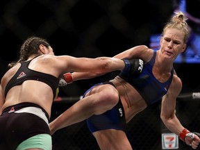 Holly Holm of United States (R) fights Bethe Correia of Brazil (L) in the WomenÕs Bantamweight Main Event Bout during UFC Singapore Fight Night at Singapore Indoor Stadium on June 17, 2017 in Singapore.