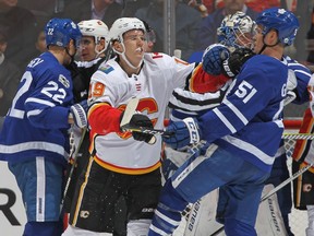 Matthew Tkachuk of the Calgary Flames battles against Jake Gardiner  of the Toronto Maple Leafs during a game  on December 6, 2017 in Toronto.