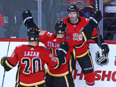 The Calgary Flames Curtis Lazar and Matt Stajan  celebrated Troy Brouwer's goal against the Vancouver Canucks during first period NHL action in Calgary Saturday December 9, 2017.