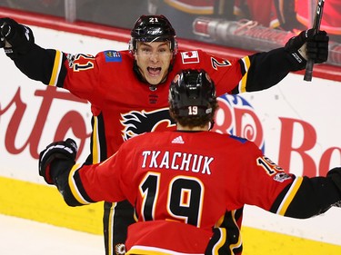 The Calgary Flames' Garnett Hathaway celebrates with Matthew Tkachuk after Tkachuk scored the tying goal against the Vancouver Canucks in the third period during NHL action in Calgary Saturday December 9, 2017.