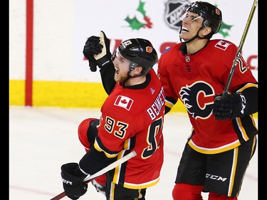 The Calgary Flames' Sam Bennett, left celebrates his game winning goal against the Vancouver Canucks with Garnett Hathaway late in the third period during NHL action in Calgary Saturday December 9, 2017.