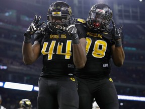 Grambling State defensive lineman Brandon Varner and defensive lineman La'Allan Clark celebrate after a second half safety during the Southwestern Athletic Conference championship football game against Alcorn State on Dec. 2, 2017