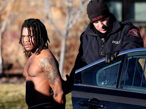 Calgary Police take a man into custody after two women alleged they were held against their will at a home in the 200 block of 42 avenue S.W. in Calgary, on Thursday December 7, 2017. Leah Hennel/Postmedia