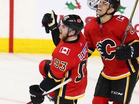 The Calgary Flames' Sam Bennett (left) celebrates his game-winning goal against the Vancouver Canucks with Garnett Hathaway late in the third period during NHL action in Calgary Saturday December 9, 2017.