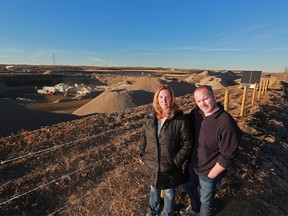Mack and Lenore Kay stand near the gravel pit directly behind their home in West Springs on Monday December 11, 2017. Residents are frustrated with regular coatings of dust and noise from the pit. Gavin Young/Postmedia