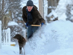 Chris Edison clears snow from a sidewalk in Crescent Heights Wednesday December 20, 2017. A winter storm hit Calgary overnight leaving over 20 centimetres in parts of the city. Gavin Young/Postmedia

Postmedia Calgary